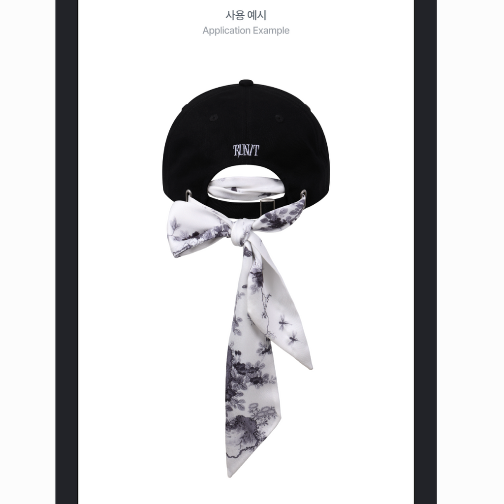A black baseball cap shown from the back with a white neck scarf tied in a bow around the strap, on a white background with small text at the top reading 'Application Example'.